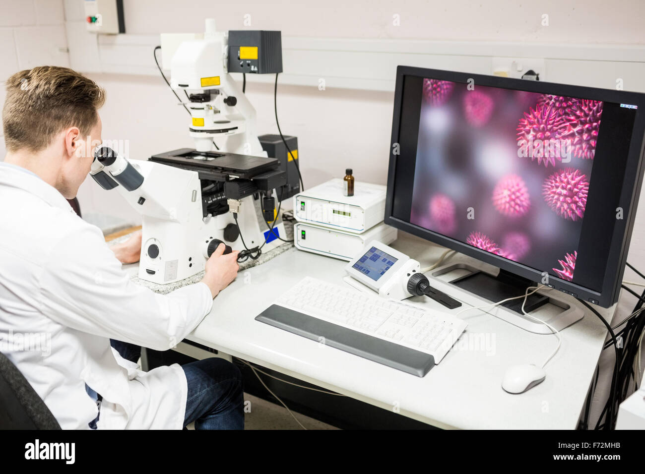 Scientist looking through a microscope Stock Photo