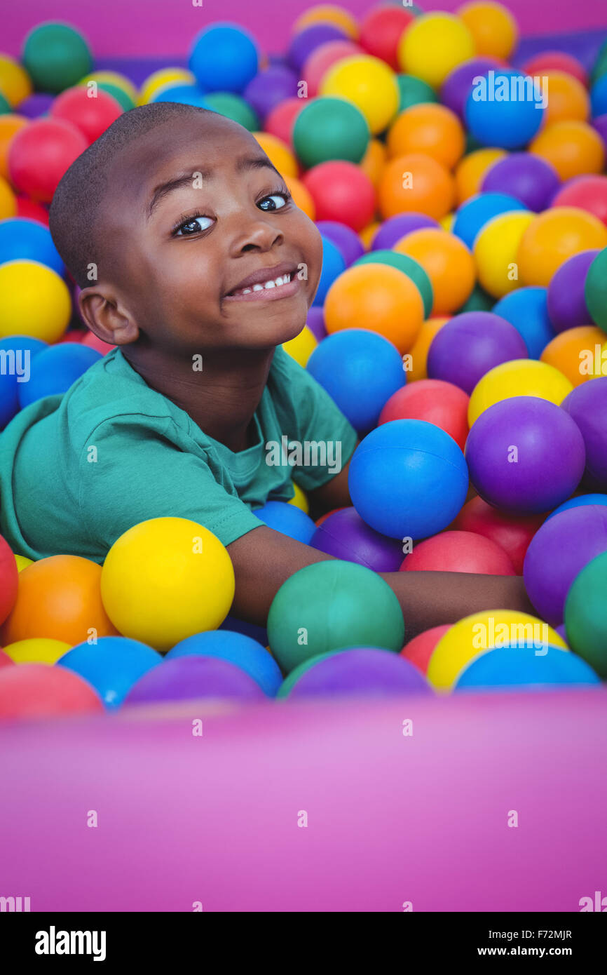 Cute smiling boy in sponge ball pool Stock Photo