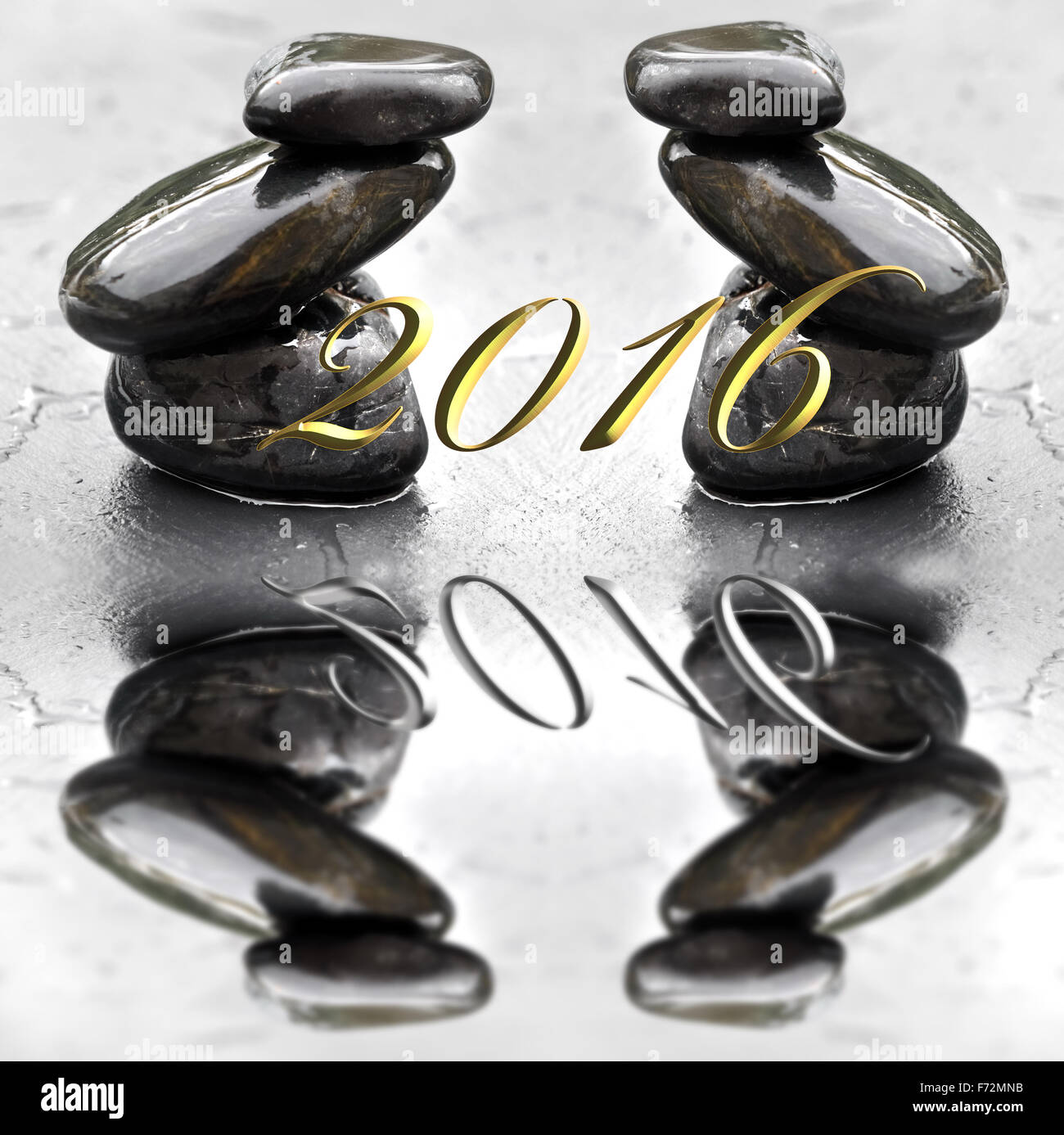 2016 greeting card balance pebbles on wet slate background Stock Photo