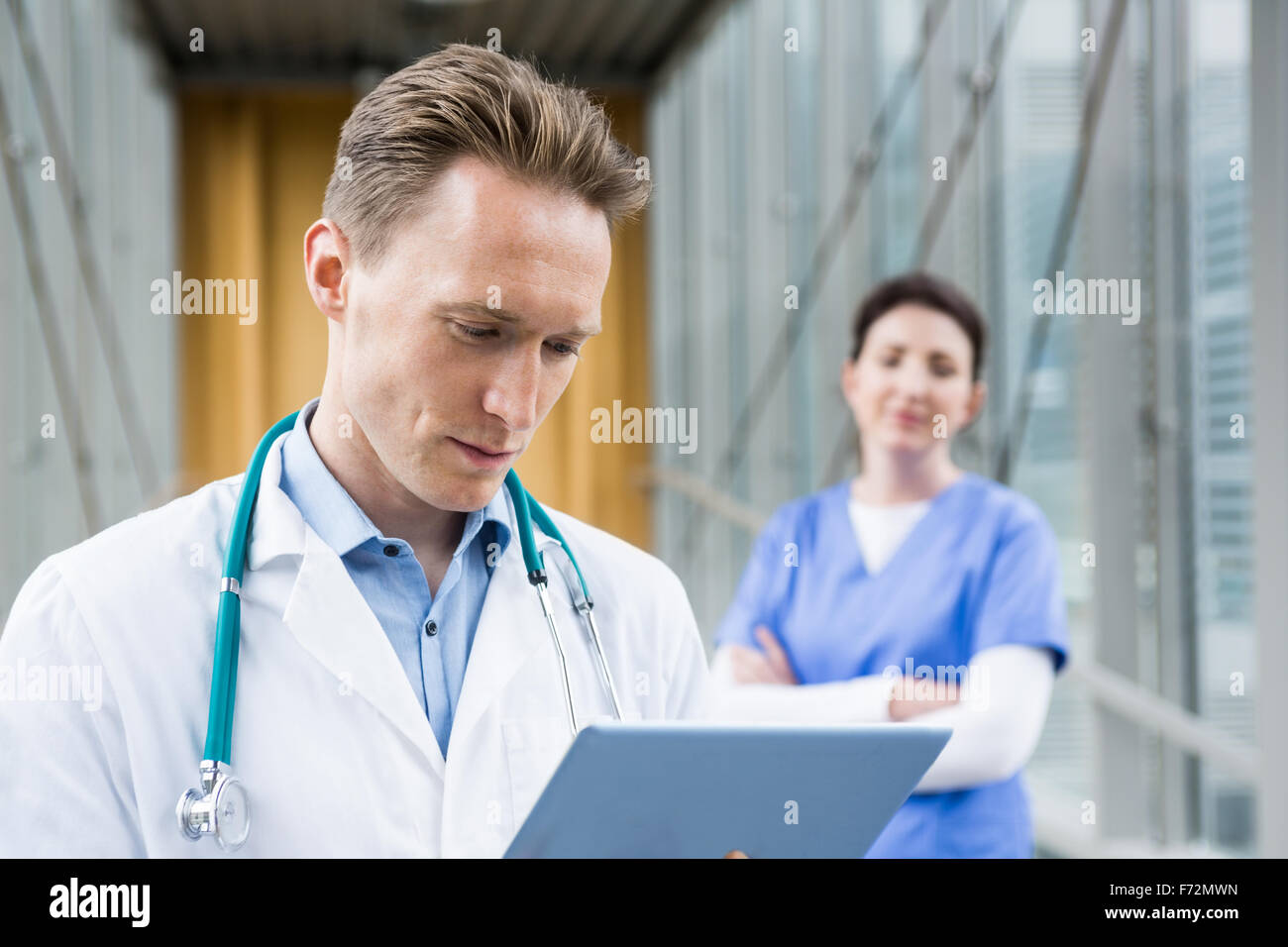 Doctor using his tablet pc Stock Photo