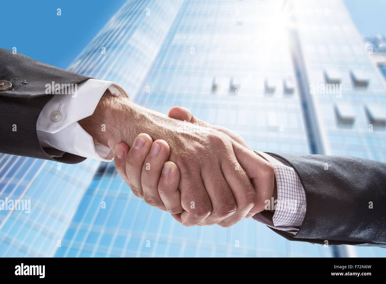 Handshake. Closeup shot of hands. The business center on the background. Stock Photo
