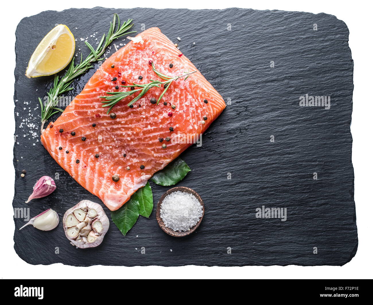 Fresh salmon on the black cutting board. File contains clipping paths. Stock Photo