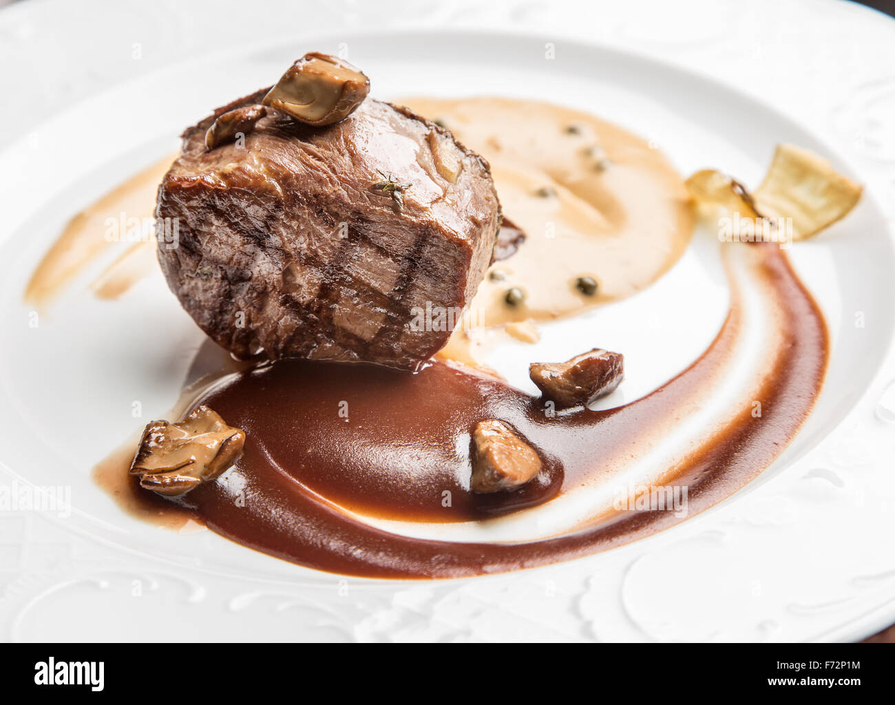 Beef steak with tomato sauce on the white plate. Stock Photo