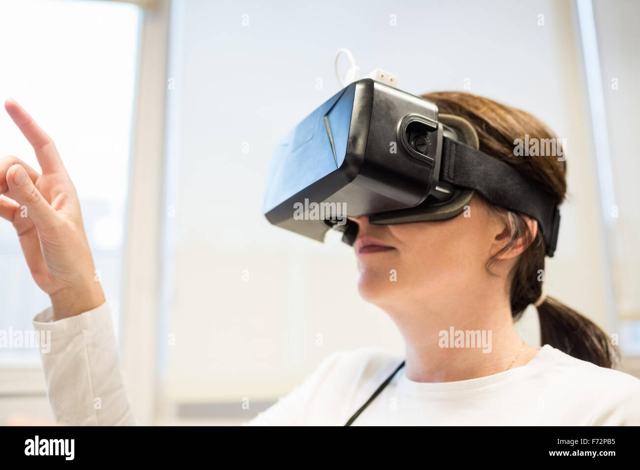 Businesswoman using oculus rift headset Stock Photo