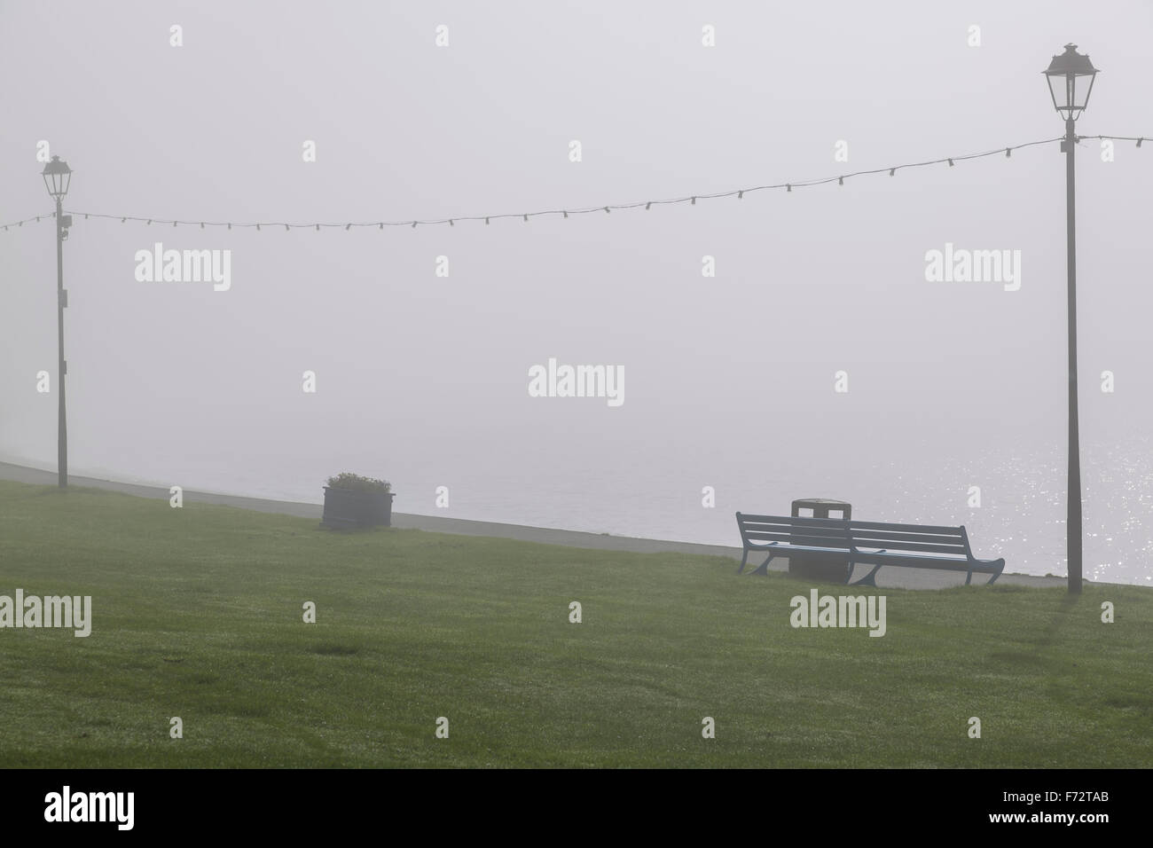 A lamppost on a seaside promenade in fog, Largs, North Ayrshire, Scotland, UK Stock Photo