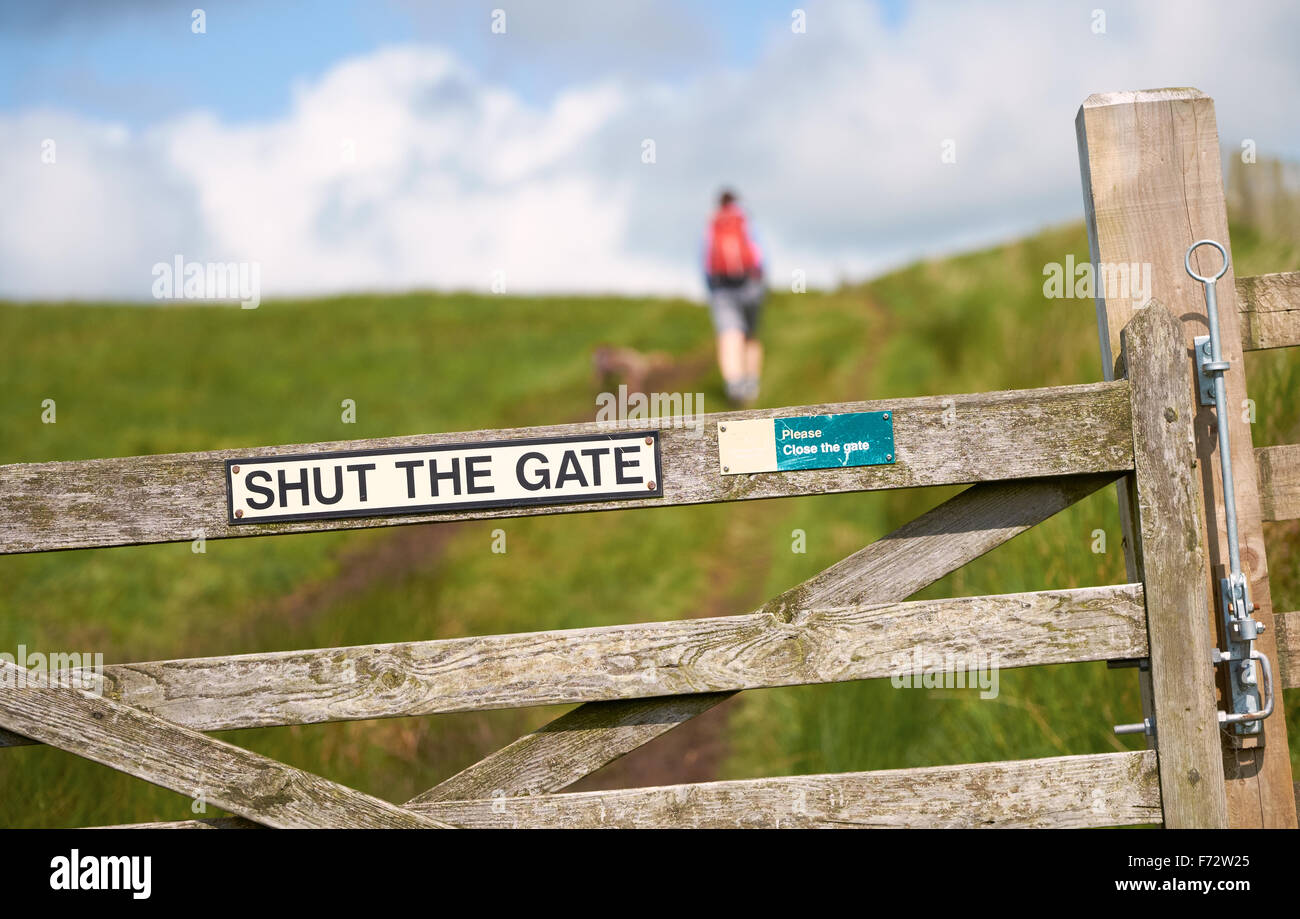 Shut The Gate sign while out walking the dog in the English countryside. Stock Photo
