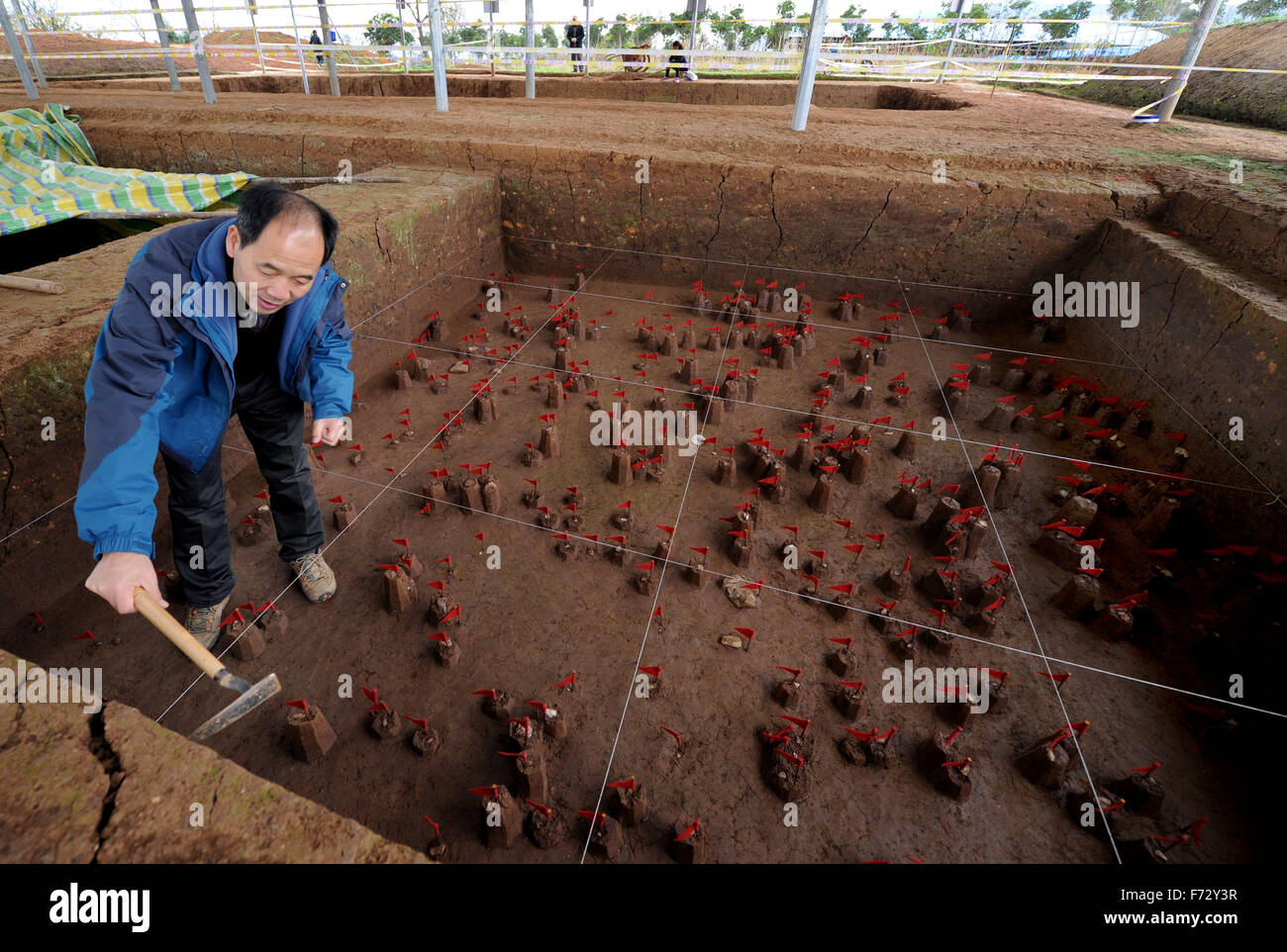 (151124) -- XI'AN, Nov. 24, 2015 (Xinhua) -- Researcher Wang Shejiang from Institute of Vertebrate Paleontology and Paleoanthropology of China Academy of Sciences works at the excavation site of the Paleolithic site at the ruins of the Longgang Temple paleoanthropological site in Hanzhong City, north China's Shaanxi Province, Nov. 24, 2015. Archeologists from Institute of Vertebrate Paleontology and Paleoanthropology of China Academy of Sciences and Shaanxi Archaeological Institute have found traces of human activities dating back to over one million years ago at the Longgang Temple Ruins. The Stock Photo