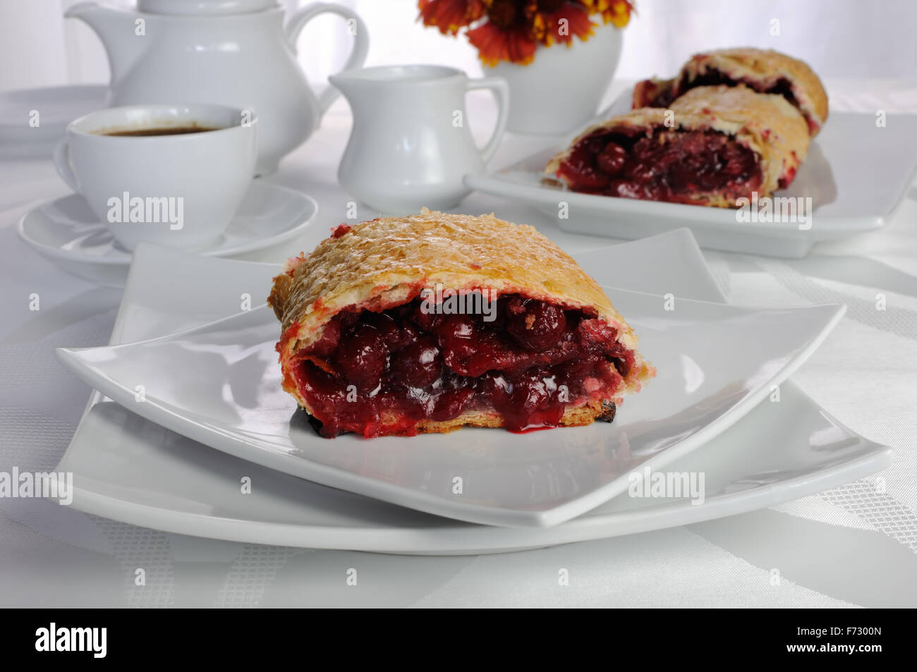 Piece of cherry strudel on the coffee table Stock Photo