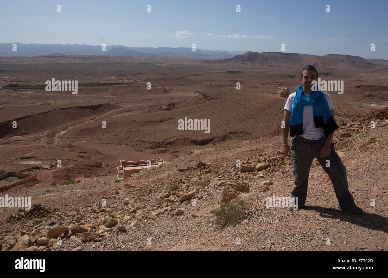 A tourist poses on a desert landscape close to Todra Gorge, Morocco Stock Photo