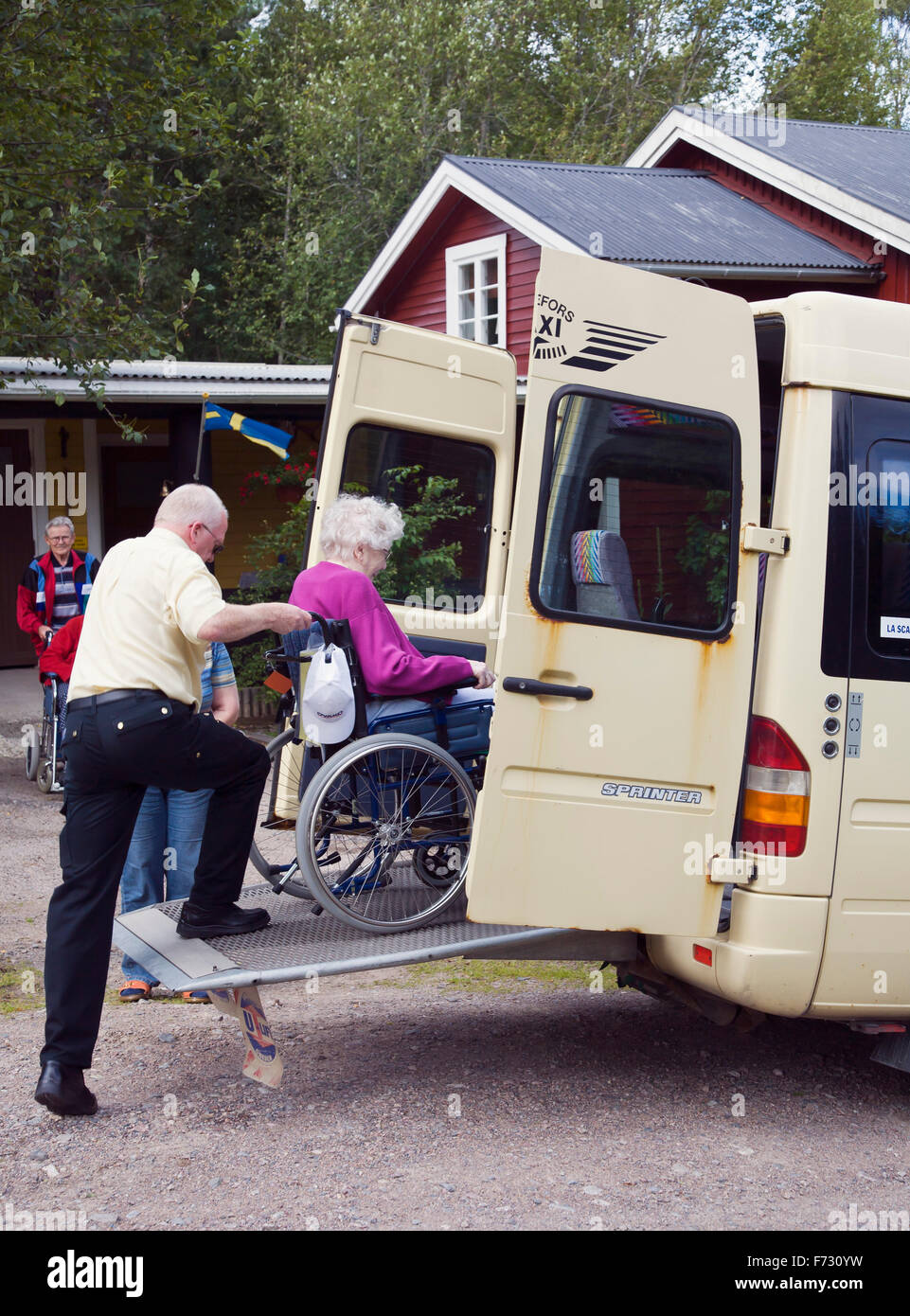 Transporting disabled woman Stock Photo