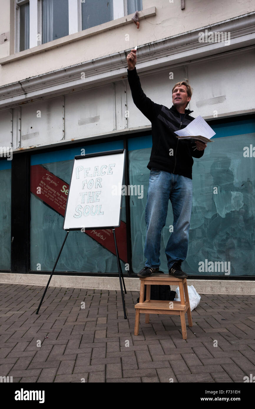 Man preaching peace for the soul, standing on a step on the street in Hastings, East Sussex, England, UK Stock Photo