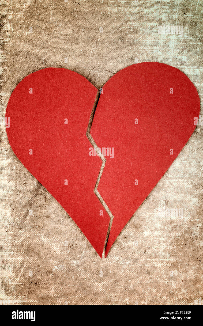 Close up of paper broken heart on blue background Stock Photo
