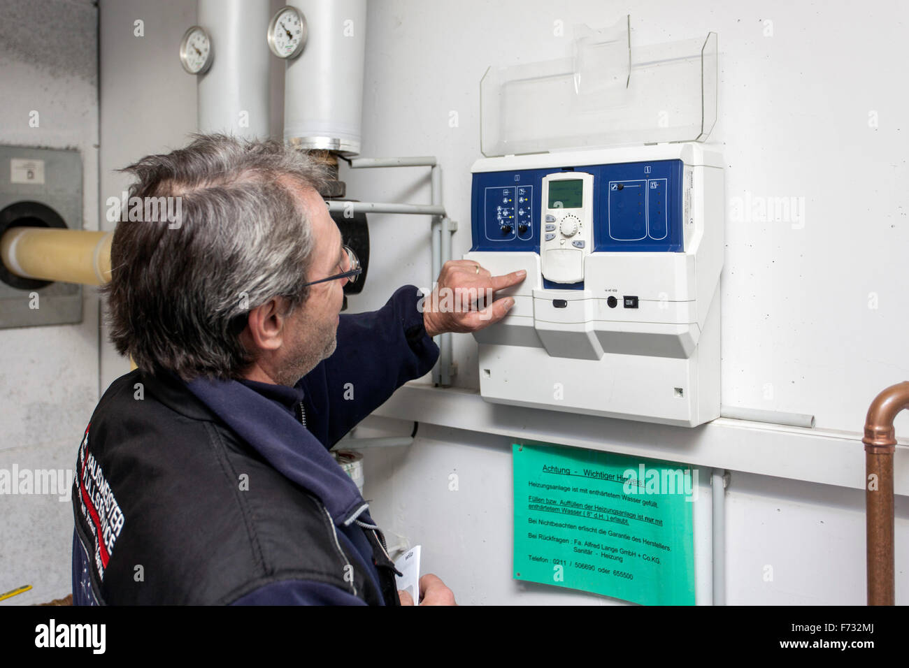 Caretaker checks the heating system in the boiler room Stock Photo Alamy