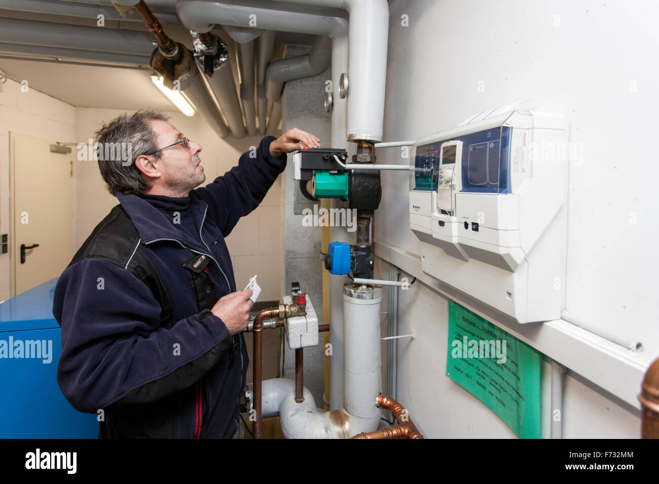 Caretaker checks the heating system in the boiler room Stock Photo