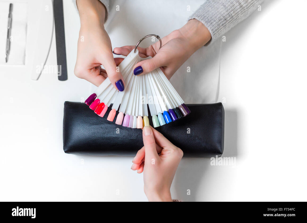 Woman selects yellow color shellac for nail Stock Photo