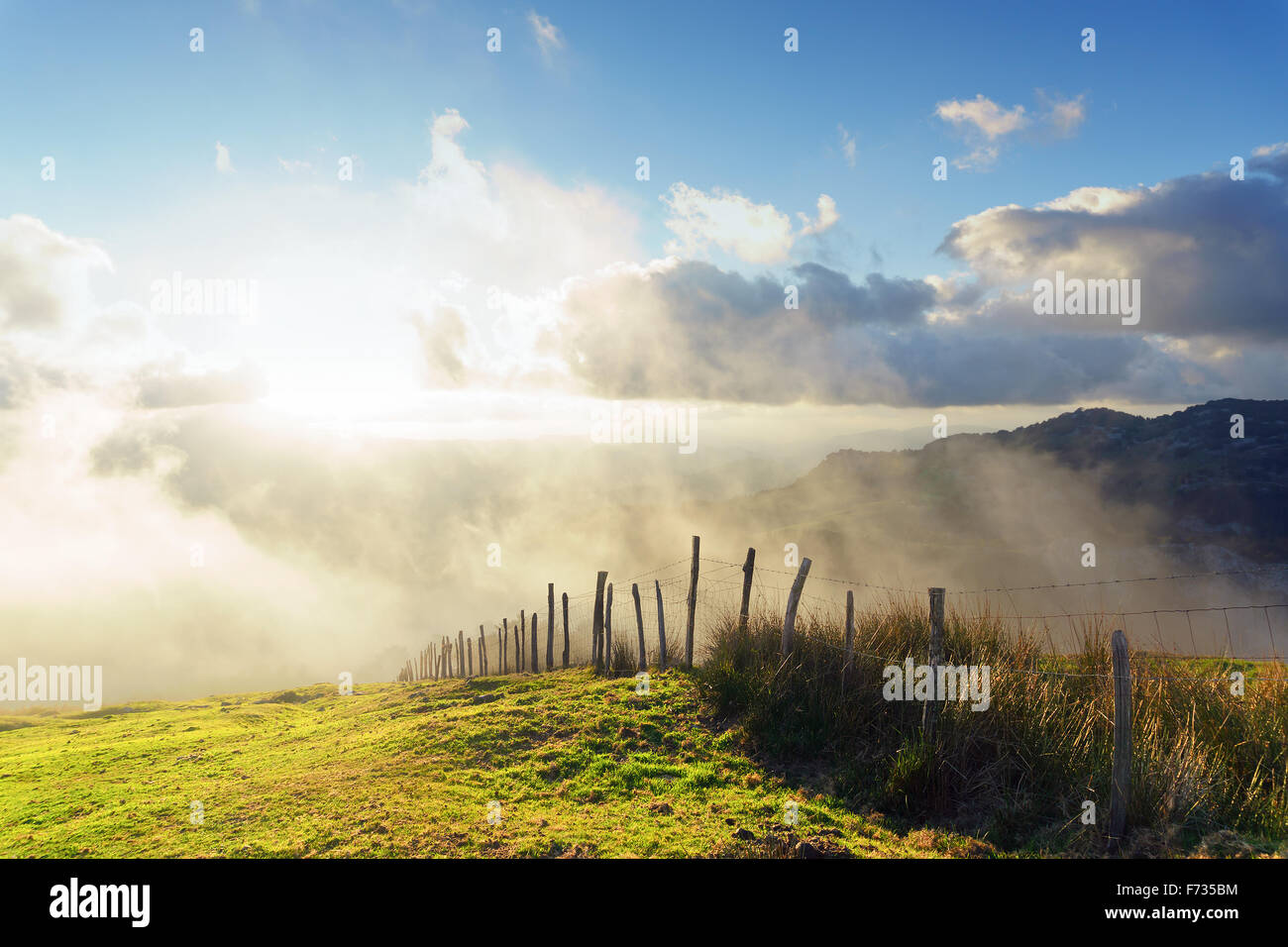 wooden fence on a foggy sunset Stock Photo - Alamy