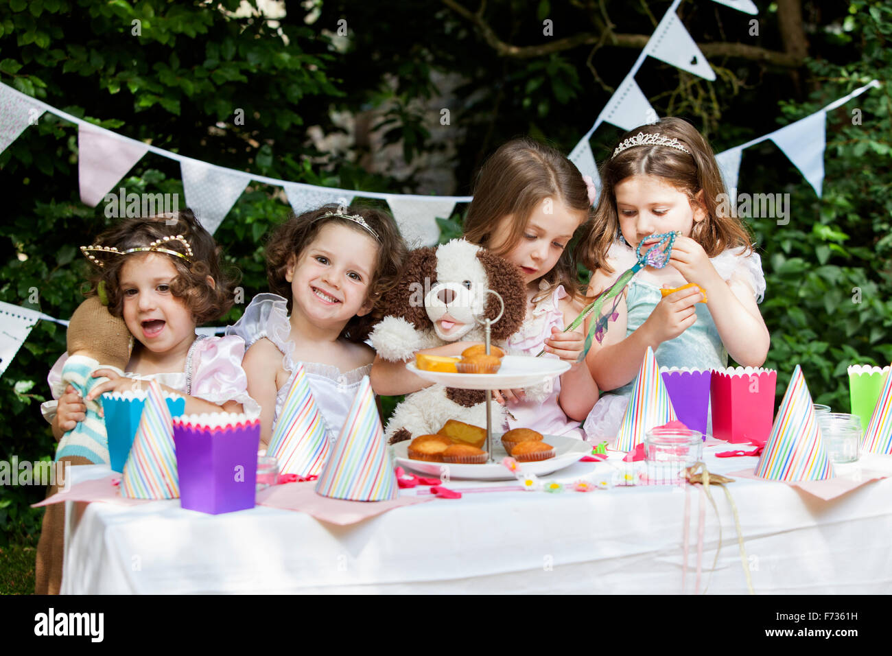 Group of young girls dressed up at a garden party. Stock Photo