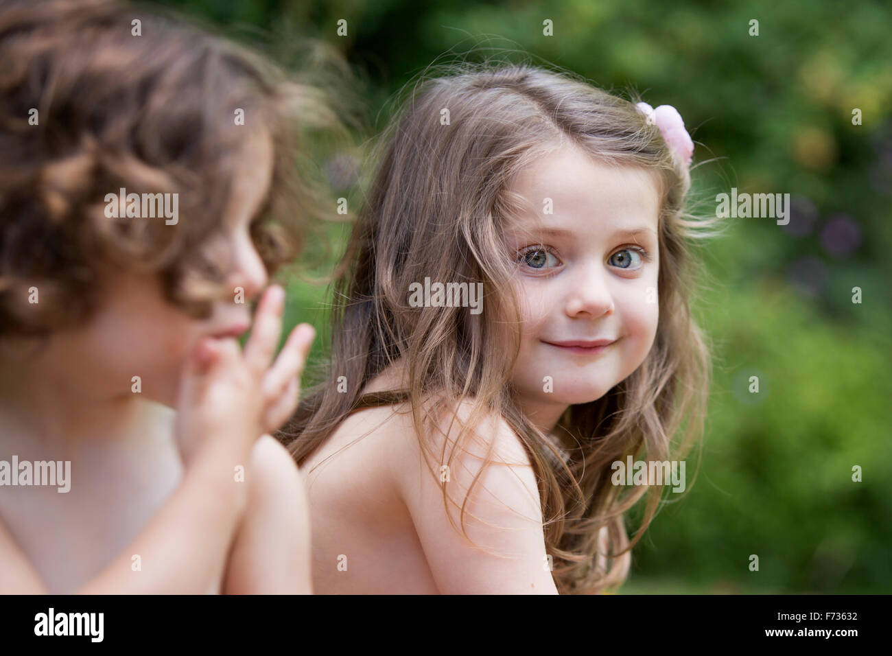 Two smiling young girls at a garden party. Stock Photo