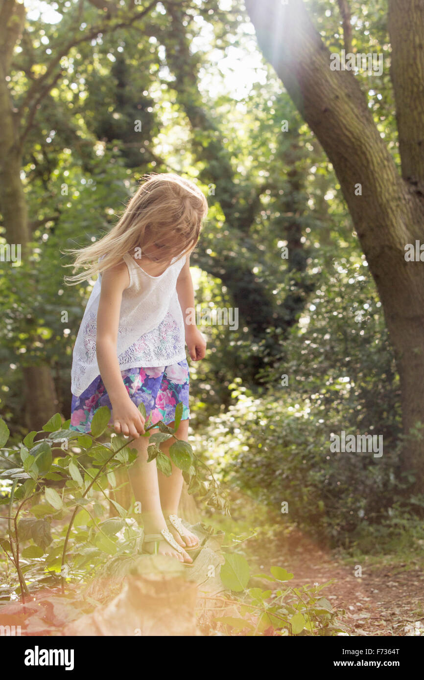 Young girl playing in a forest Stock Photo - Alamy