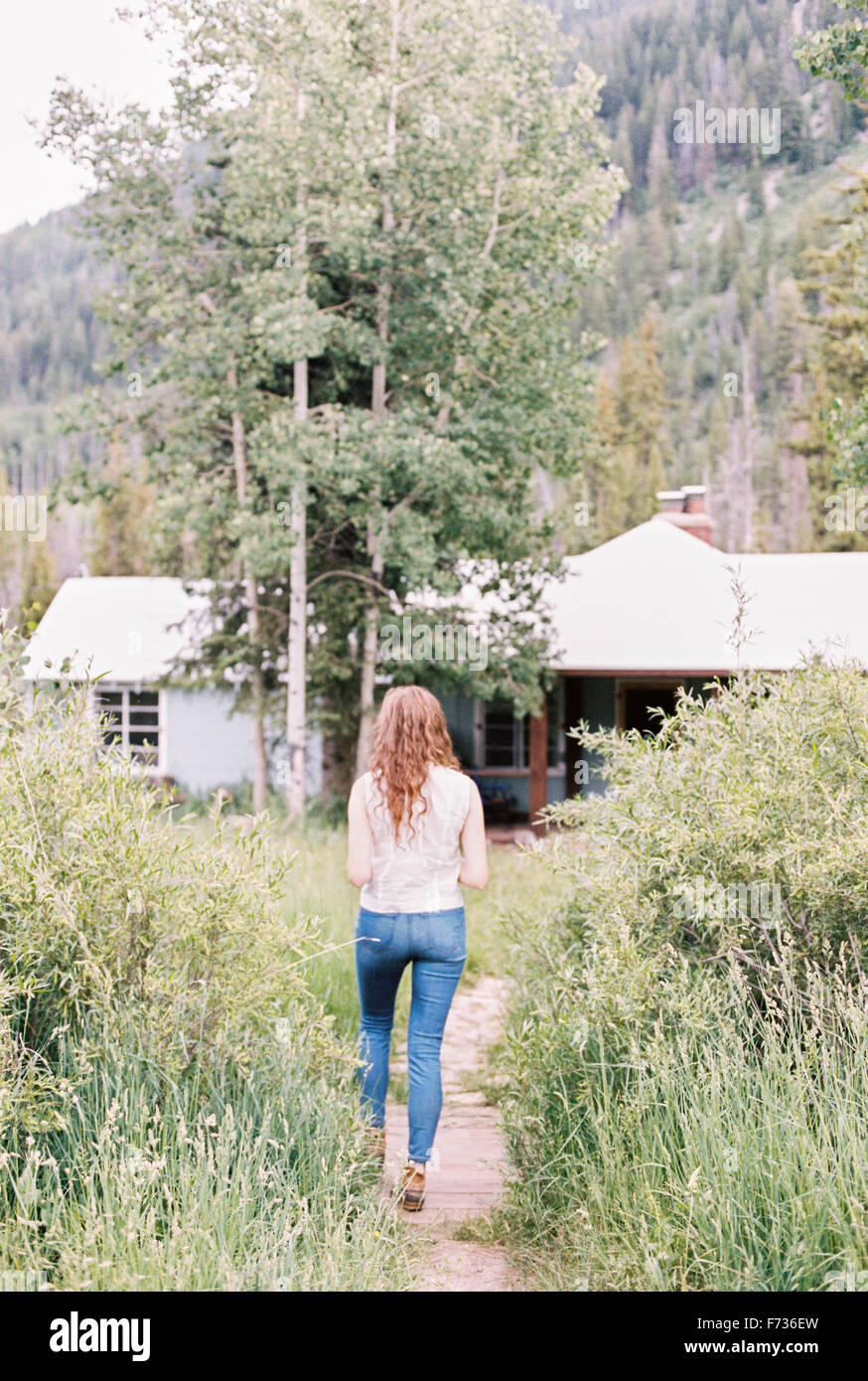 Woman walking along a footpath on a ranch. Stock Photo