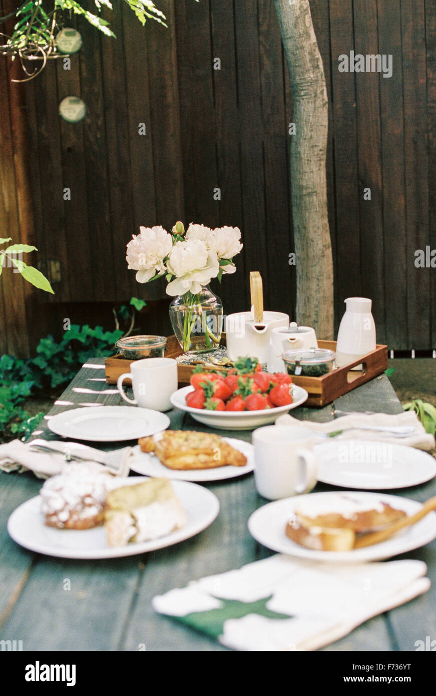 Breakfast table with tea, pastries and fresh strawberries. Stock Photo