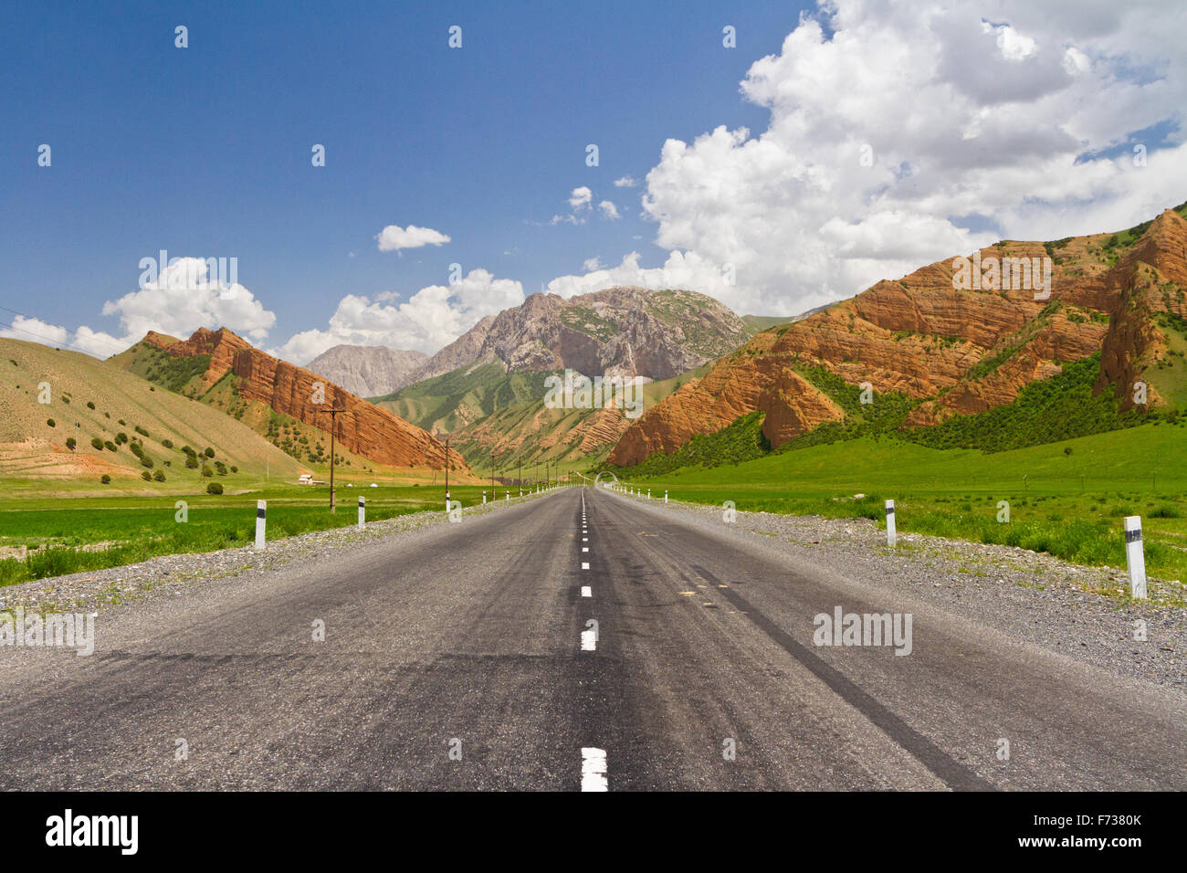 The road leading towards Gulcho in Kyrgyzstan offers stunning views with the striking colors from the mountains. - Stock Image