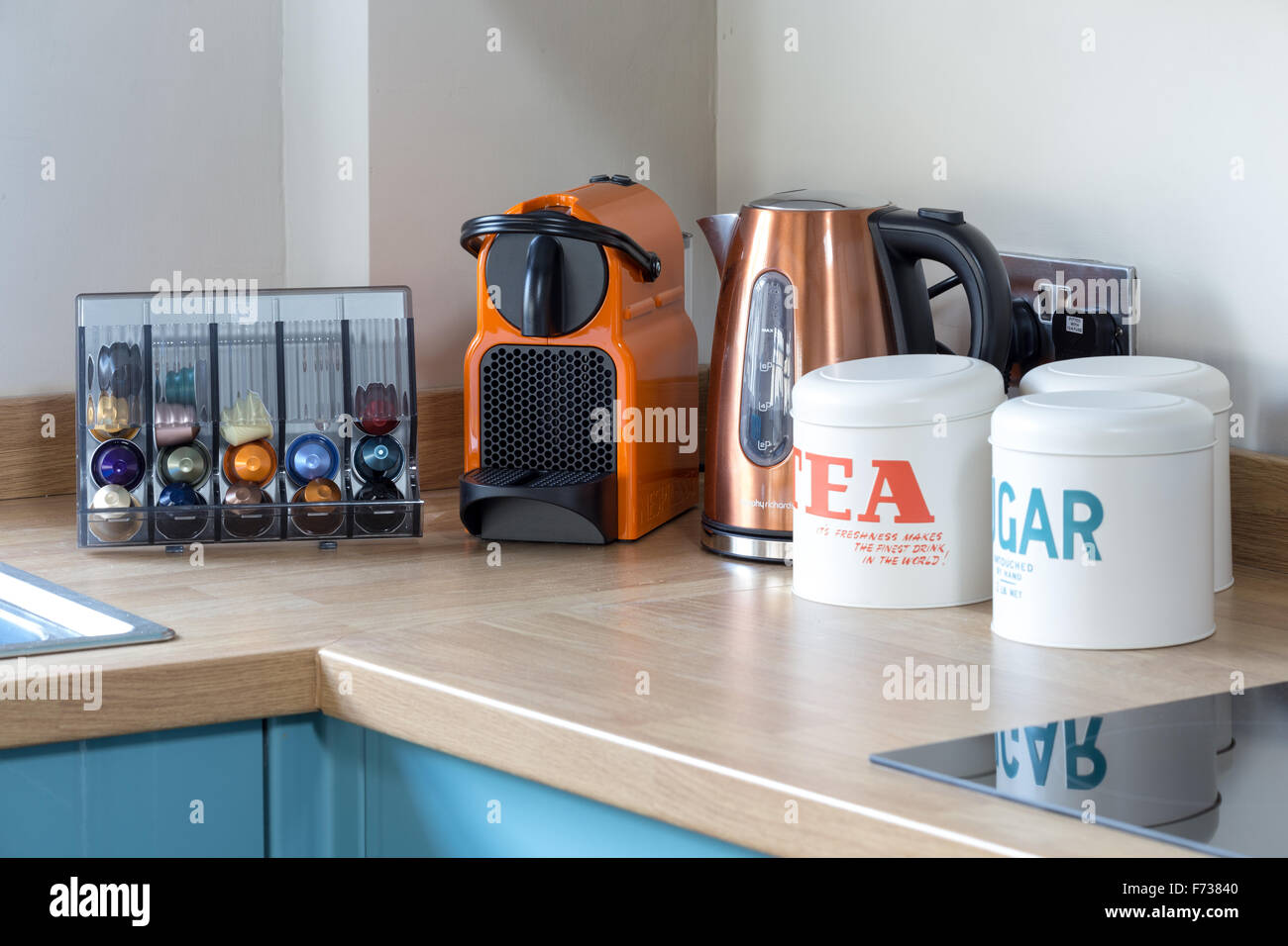 Contemporary kitchen surface with kettle and Nespresso coffee maker Stock Photo