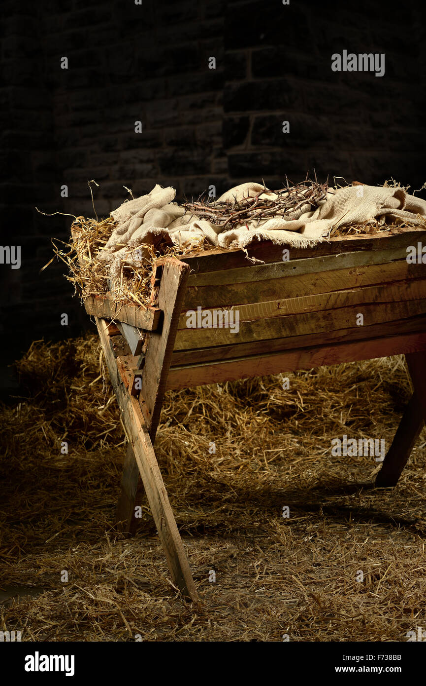 Manger with crown of thorns. Conceptual representation of the birth and death of Christ. Stock Photo