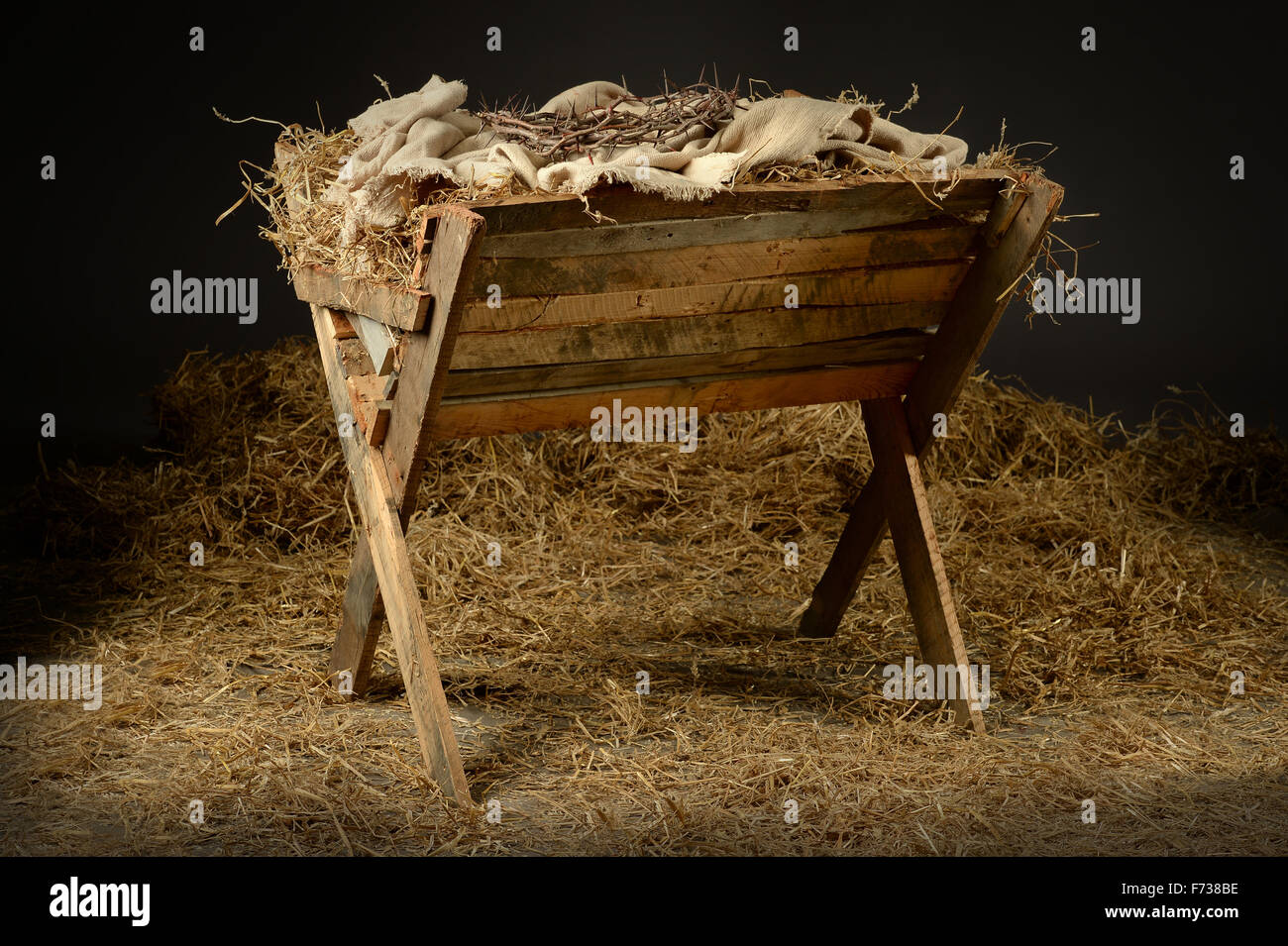 Manger with crown of thorns in barn. Concept based on the birth and death of Jesus. Stock Photo