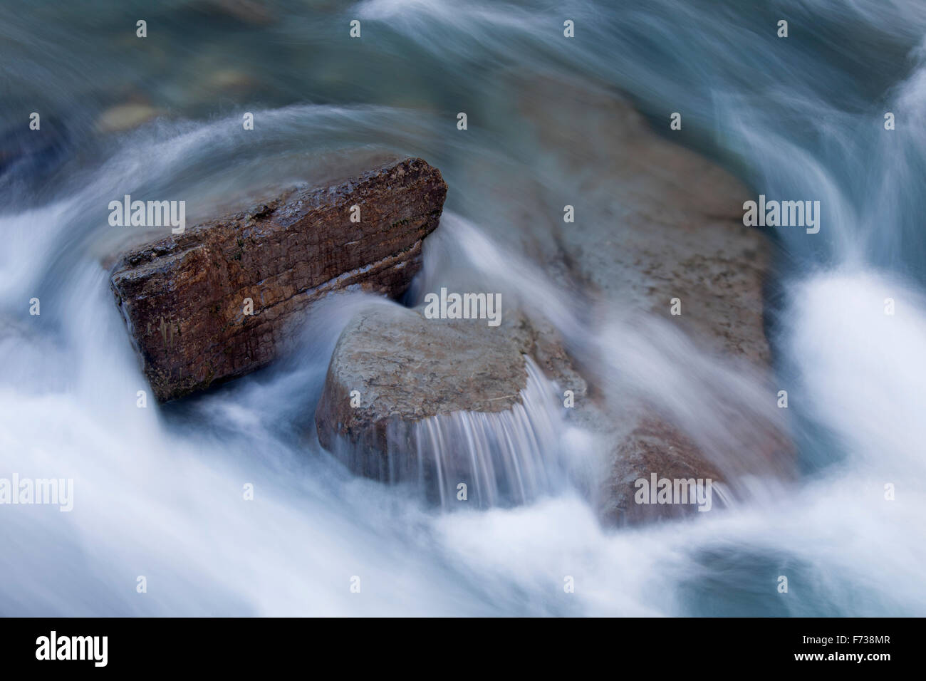 Detail of creek showing water flowing over rocks in the Maligne Canyon ...