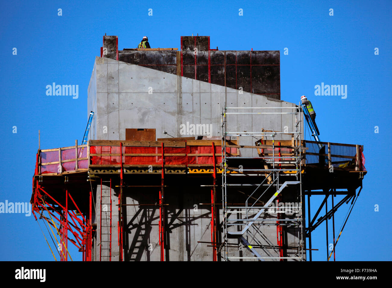 Men work on the construction of an elevator shaft structure Stock Photo