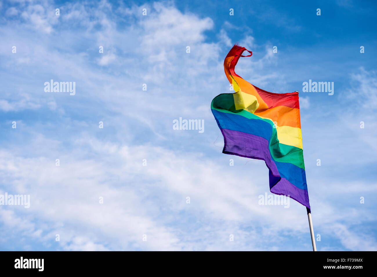 A gay pride rainbow flag flies with a blue sky background Stock Photo ...