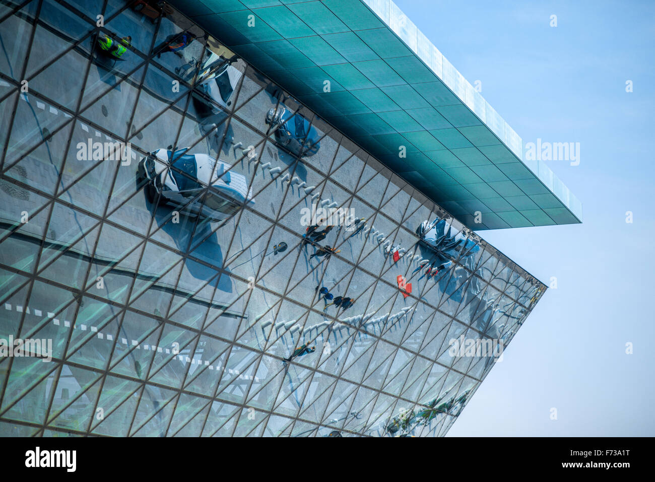Modern airport terminal facade with cars and people's reflections Stock Photo