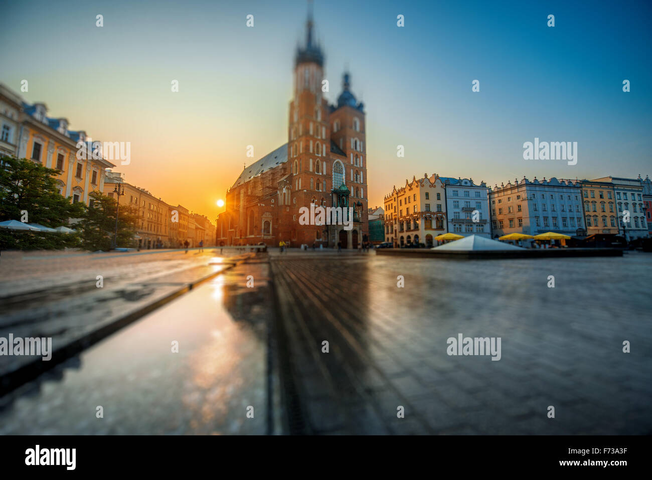 Beautiful view on St. Mary's Basilica at the market square in Krakow on the sunrise. Wide angle view with tilt shift effect Stock Photo
