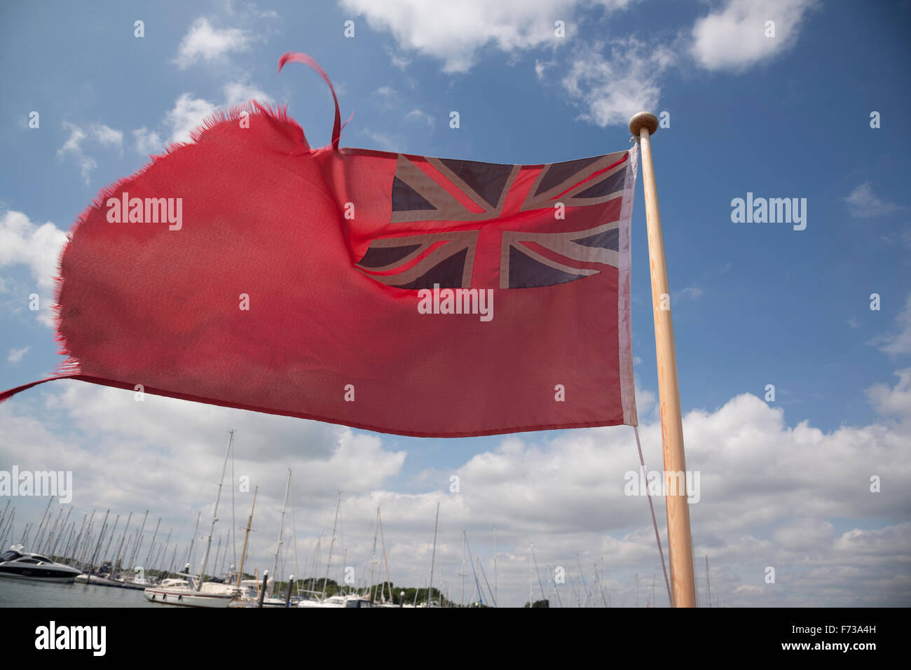 Red ensign flag flying on the stern of a civilian boat in lymington