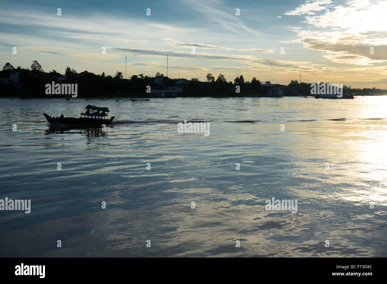Chau Doc, Vietnam Boat at sunrise on the Mekong River, viewed from the