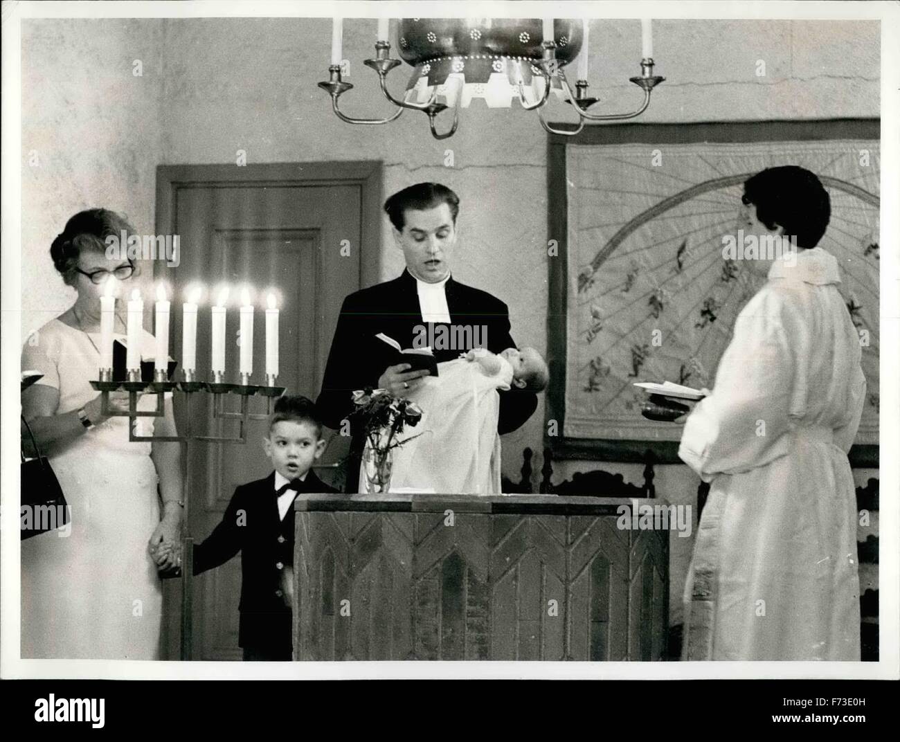 1964 - Woman Priest Barbro Nordholm- Stahl Christening her Daughter in the Church Essinge in Stockholm. The Name of the Little kid is Kristina Darbro Elisadet. Next to them stands the father who also is a Priest, Olle Stahl, The Couples six years old son Krister and the Grandmother (Mother of the Woman Priest ) Ester Nordholm. © Keystone Pictures USA/ZUMAPRESS.com/Alamy Live News Stock Photo