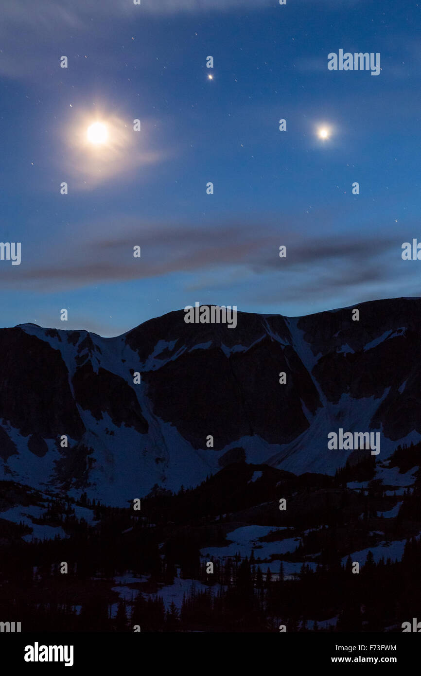 Venus and Jupiter form a perfect triangle with a crescent moon above the Snowy Range, Medicine Bow National Forest, Wyoming Stock Photo
