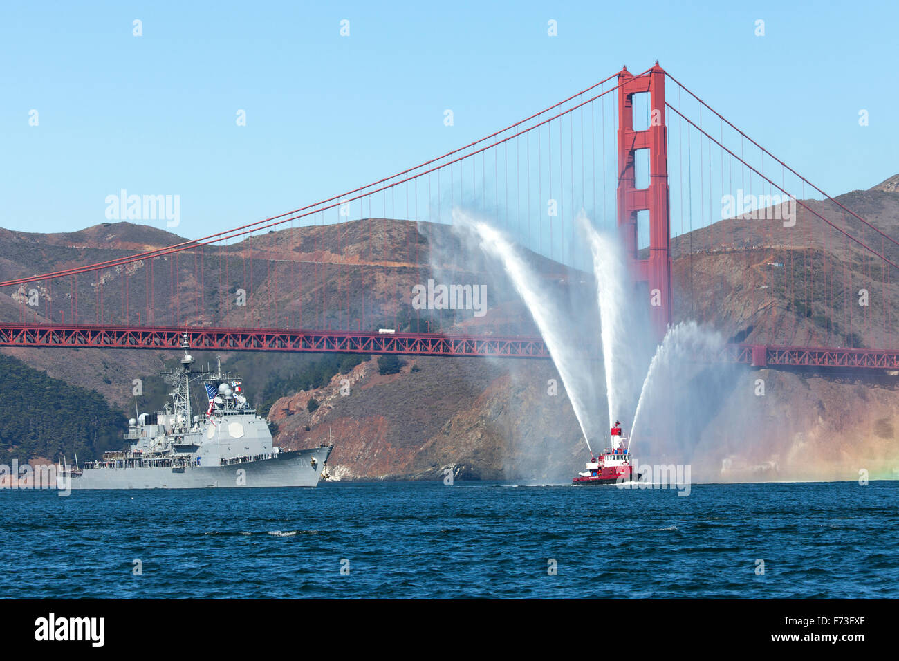 The Arleigh Burke-class guided-missile destroyer USS Ross (DDG-71) is escorted through the Golden Gate. Stock Photo