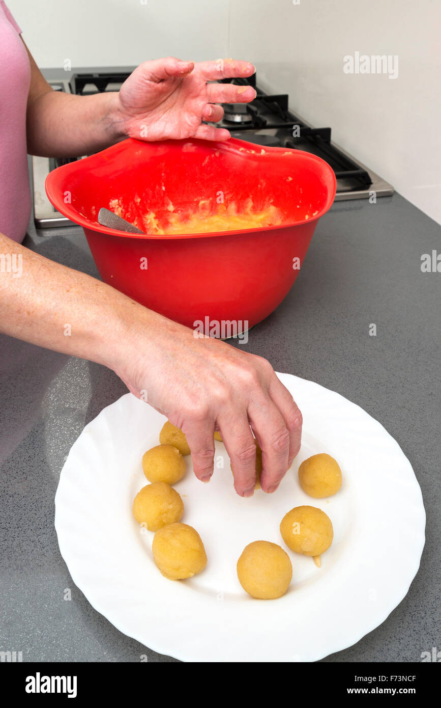 Woman kneading marzipan for make panellets  in the kitchen. Stock Photo