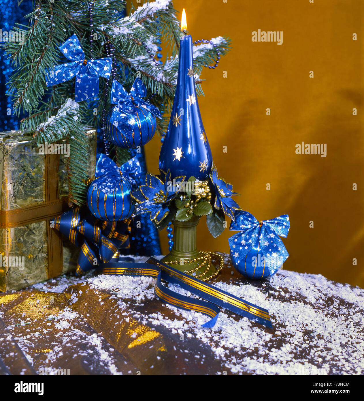 Festive New Year's, Christmas still life in blue-brown tones with blue Christmas balls, a candle and Christmas gifts. Stock Photo