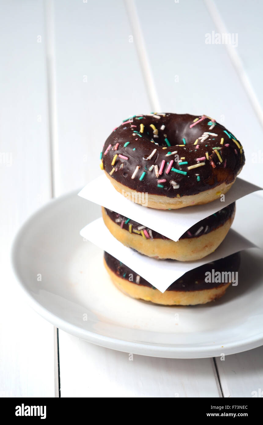 Group of glazed donuts on white wooden background Stock Photo - Alamy