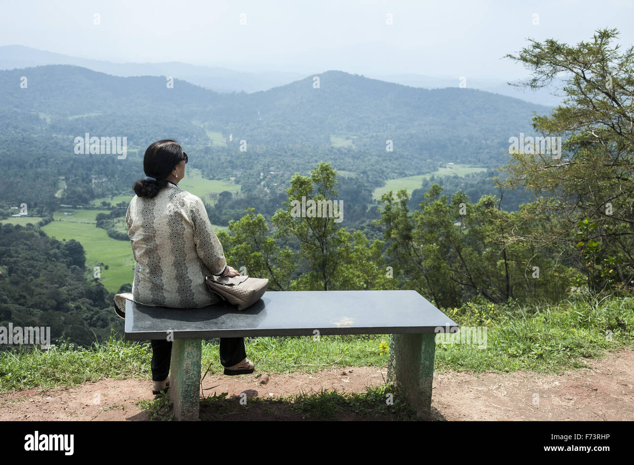 Woman sitting on bench, raja garden, coorg, karnataka, india, asia   model released Stock Photo