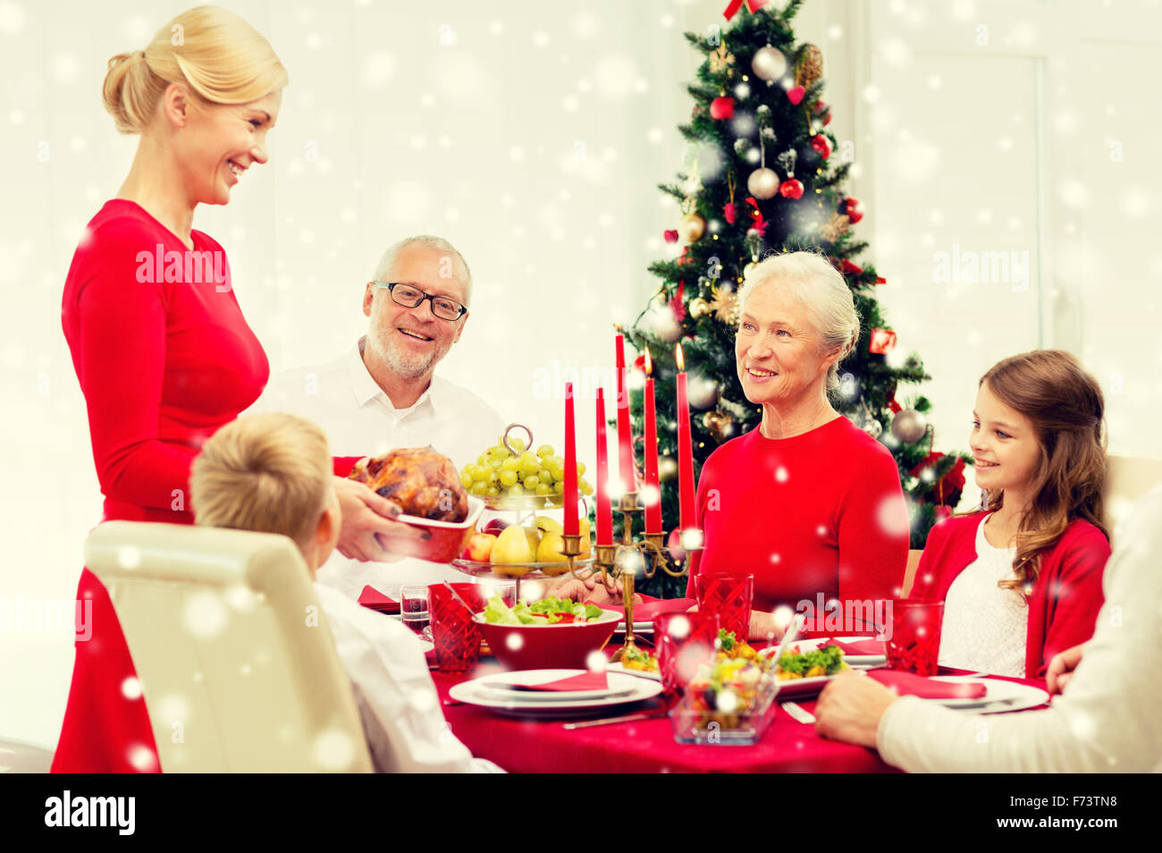 smiling family having holiday dinner at home Stock Photo - Alamy