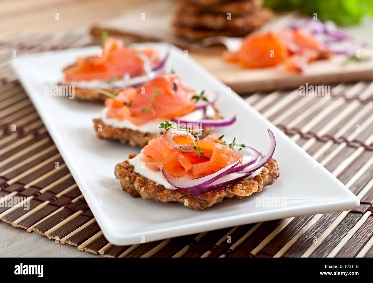Buckwheat pancakes with salted salmon and sour cream close up Stock Photo