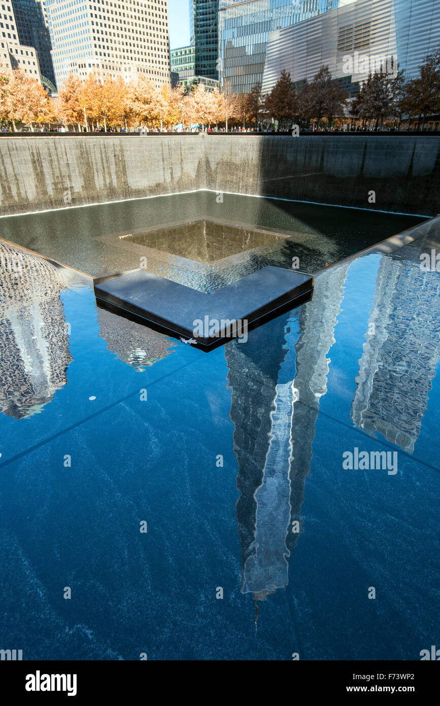 Southern Pool of National September 11 Memorial & Museum with One World Trade Center reflected, Lower Manhattan, New York, USA Stock Photo