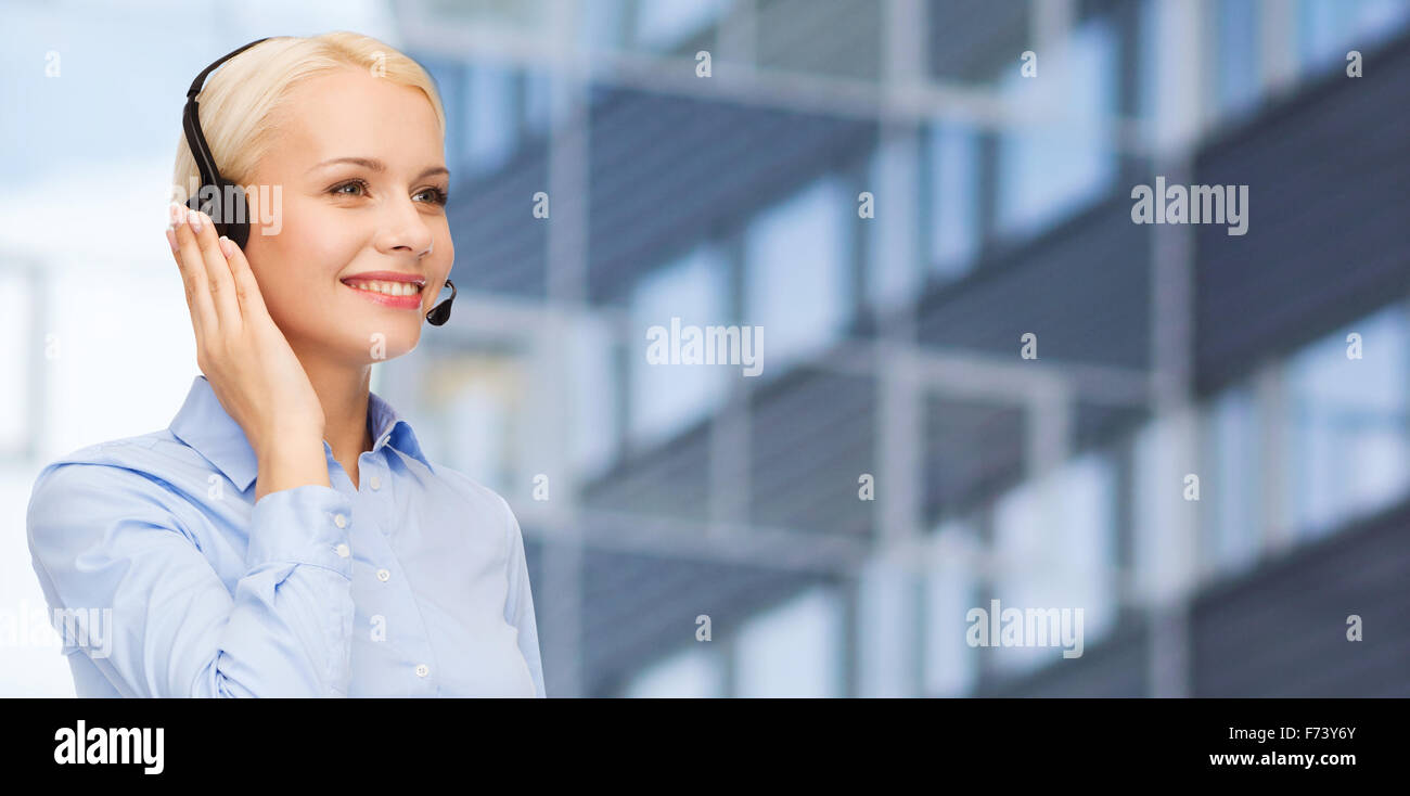 helpline operator in headset over business center Stock Photo