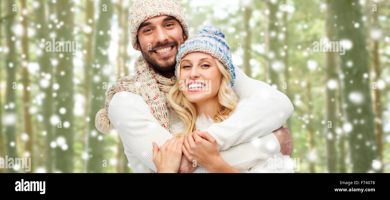 happy couple in winter clothes hugging over forest Stock Photo - Alamy