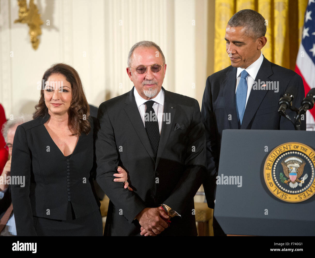 Gloria and Emilio Estefan (C) stand to receive the Presidential Medal of Freedom from United States President Barack Obama during a ceremony in the East Room of the White House in Washington, DC on Tuesday, November 24, 2015. The Medal is the highest US civilian honor, presented to individuals who have made especially meritorious contributions to the security or national interests of the US, to world peace, or to cultural or significant public or private endeavors. Photo: Ron Sachs/CNP/dpa - NO WIRE SERVICE - Stock Photo