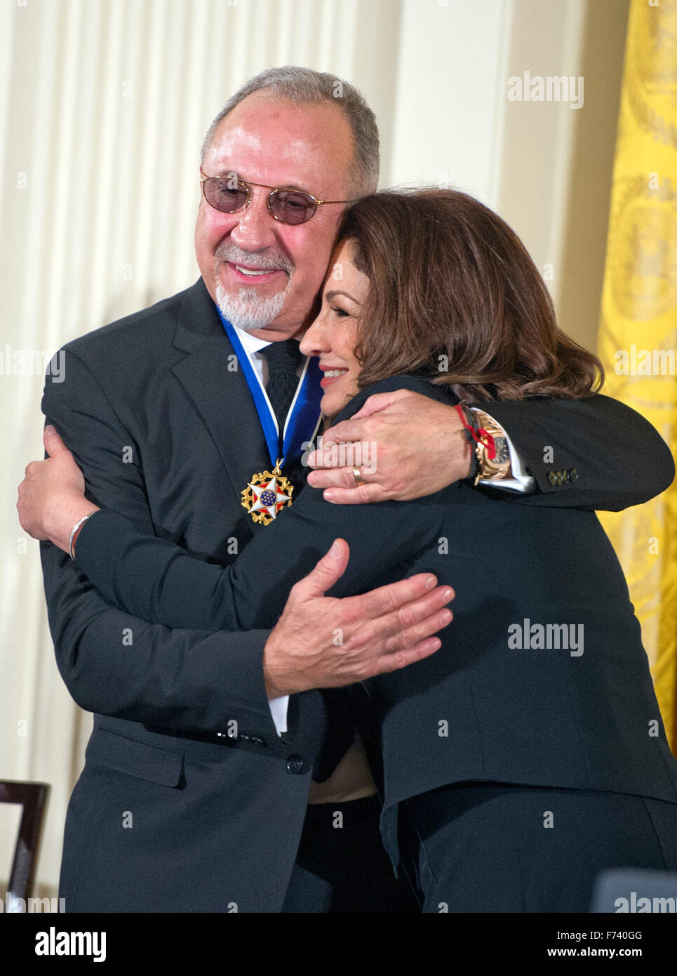 Presidential Medal of Freedom recipients Gloria and Emilio Estefan share a hug following the ceremony in the East Room of the White House in Washington, DC on Tuesday, November 24, 2015. The Medal is the highest US civilian honor, presented to individuals who have made especially meritorious contributions to the security or national interests of the US, to world peace, or to cultural or significant public or private endeavors. Photo: Ron Sachs/CNP/dpa - NO WIRE SERVICE - Stock Photo